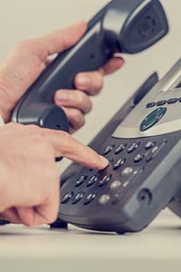 Retro image of a businessman dialing a phone number